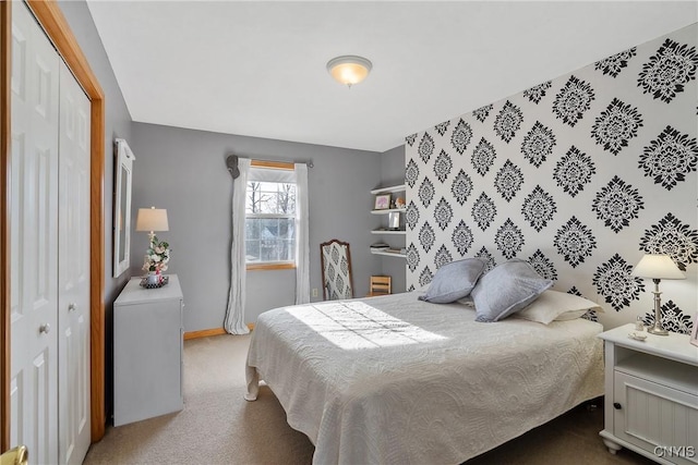 bedroom with a closet, carpet flooring, and baseboards