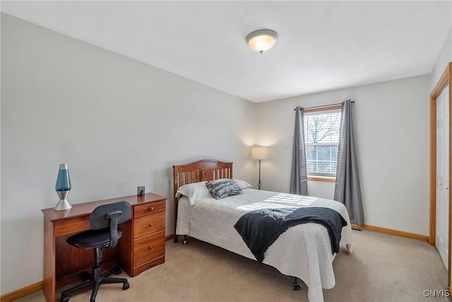 bedroom featuring light colored carpet and baseboards