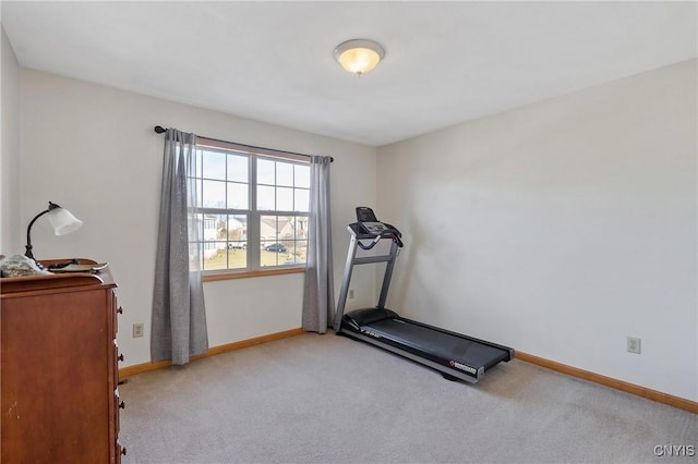 exercise area with baseboards and carpet