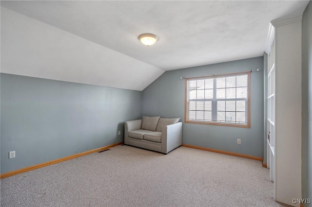 unfurnished room featuring baseboards, carpet flooring, and vaulted ceiling