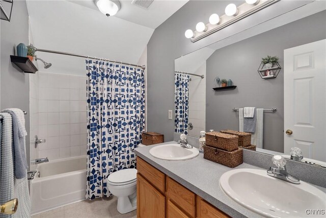 bathroom with visible vents, shower / bath combination with curtain, toilet, and a sink