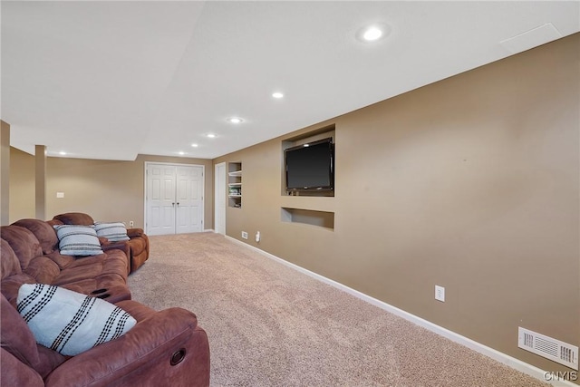 carpeted living area with visible vents, recessed lighting, built in shelves, and baseboards