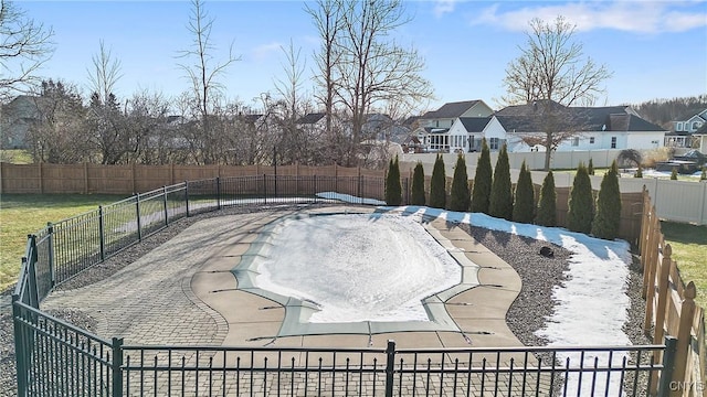 view of swimming pool featuring a residential view and a fenced backyard