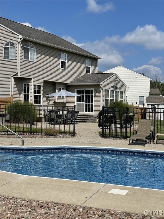 view of pool with a fenced in pool, fence, and a patio area