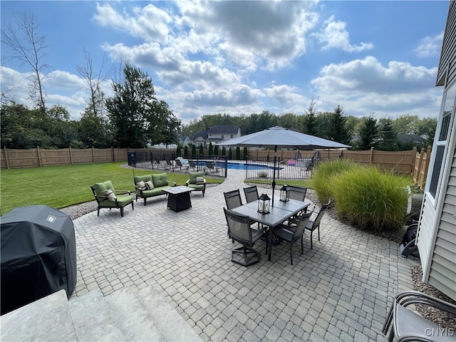 view of patio featuring a fenced in pool, a grill, outdoor dining area, and a fenced backyard