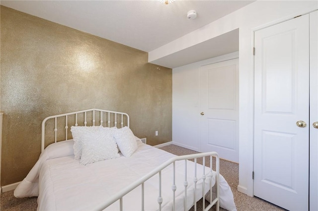 bedroom featuring carpet flooring and baseboards