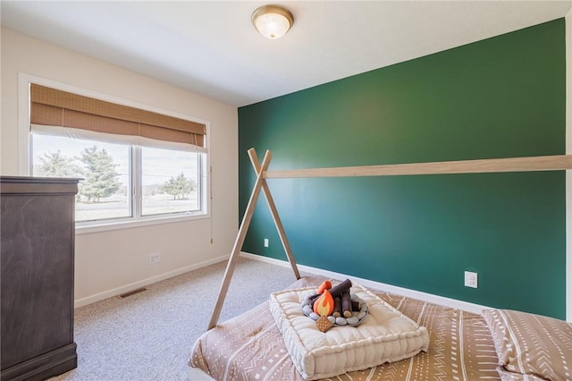 carpeted bedroom featuring visible vents and baseboards