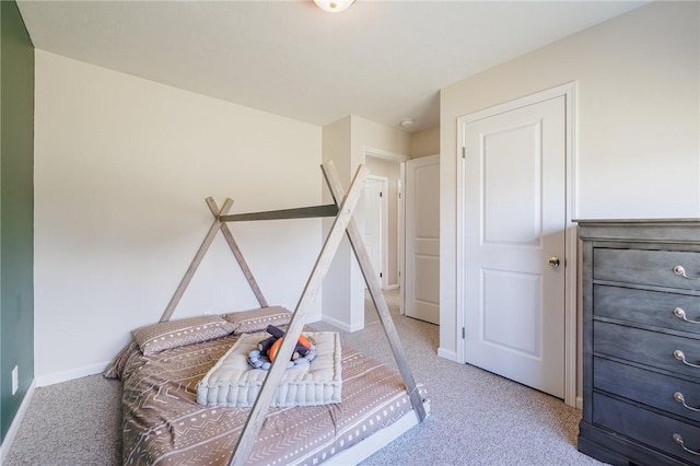 interior space with baseboards and light colored carpet