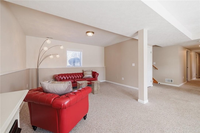 living area featuring stairway, visible vents, baseboards, and light carpet