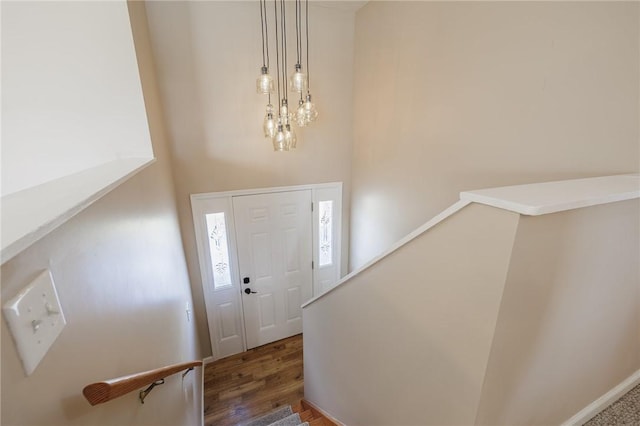 foyer entrance featuring stairs and wood finished floors