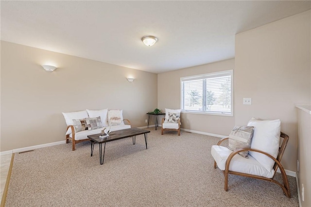 living area featuring light carpet, visible vents, and baseboards