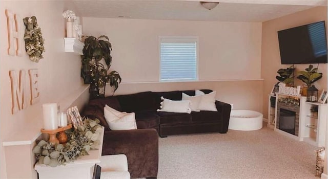 living area with a fireplace, carpet, and visible vents