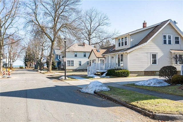 view of front of home featuring a residential view and a chimney