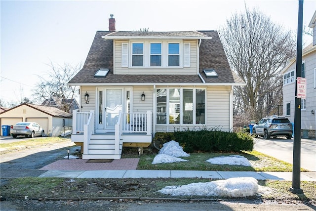 bungalow featuring roof with shingles and a chimney