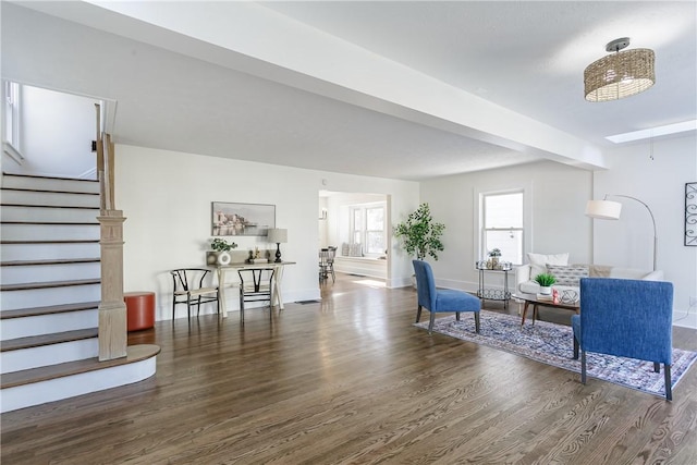 living area featuring stairway, baseboards, and wood finished floors