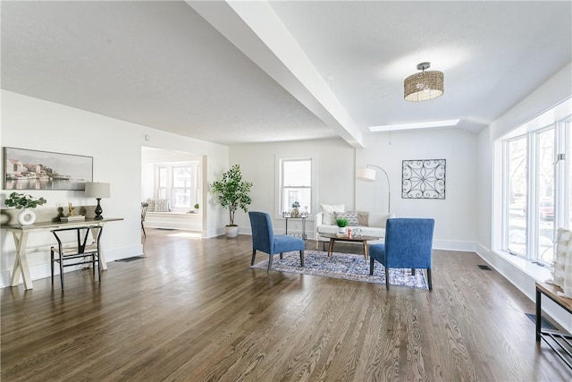 interior space with visible vents, baseboards, and wood finished floors