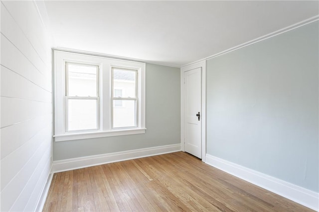 unfurnished room featuring light wood-type flooring and baseboards