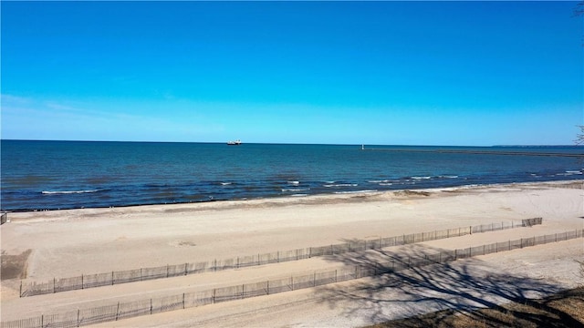 water view with a view of the beach and fence