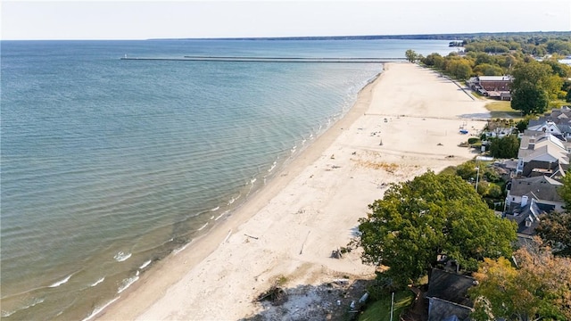 drone / aerial view featuring a beach view and a water view