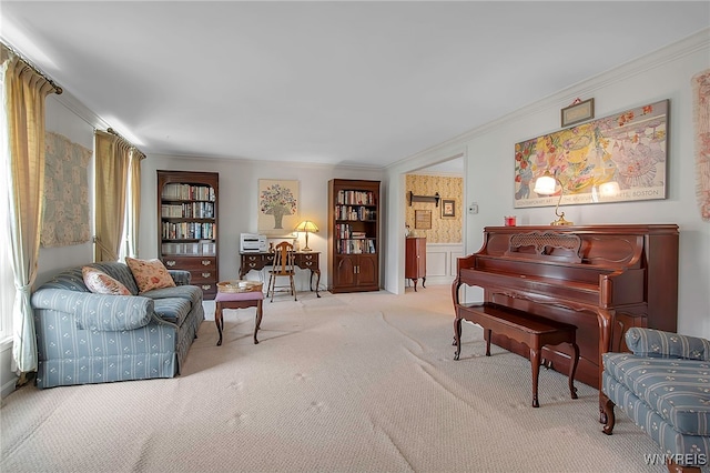 living area featuring a wainscoted wall, ornamental molding, a decorative wall, and carpet floors