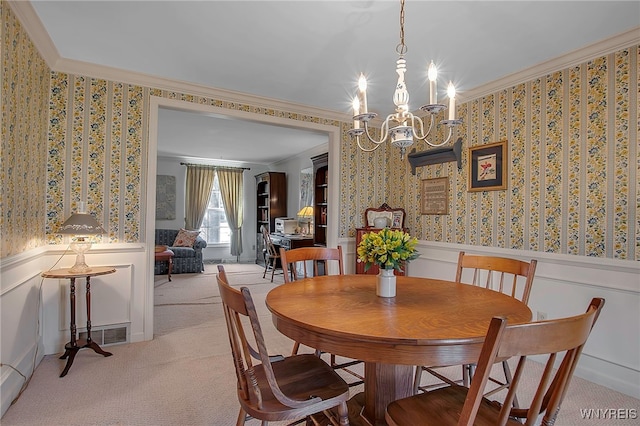 dining space with light colored carpet, ornamental molding, wainscoting, and wallpapered walls