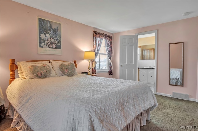 bedroom featuring ensuite bathroom, baseboards, visible vents, and carpet floors