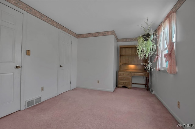 unfurnished bedroom with carpet, visible vents, and baseboards