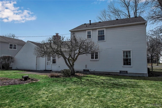 back of property with a lawn and a chimney