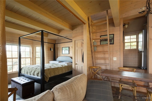 bedroom with beam ceiling, wood ceiling, and wood walls