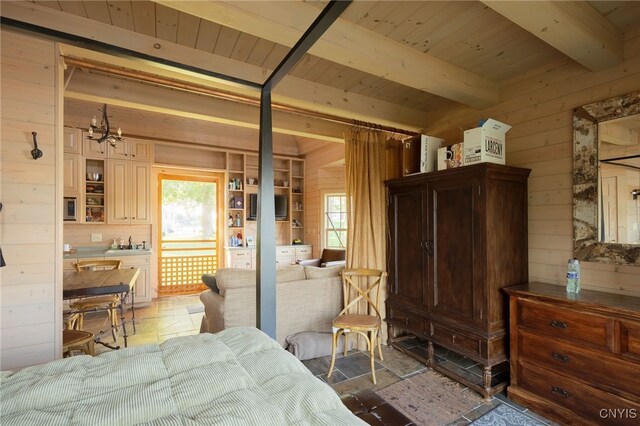 bedroom featuring wooden walls, stone tile flooring, wood ceiling, beamed ceiling, and a chandelier