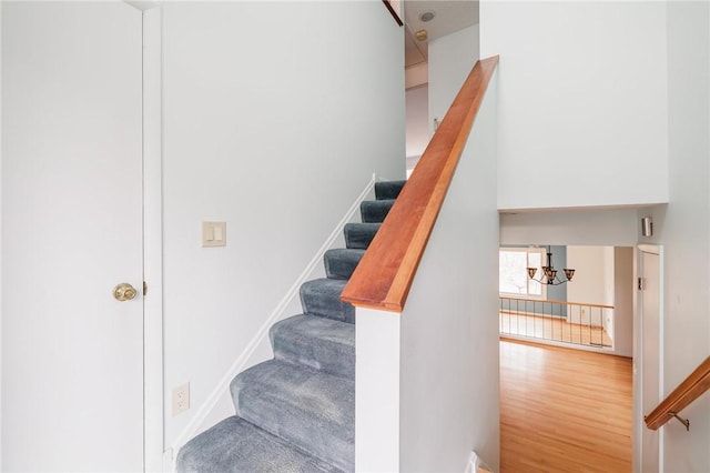 stairs with wood finished floors and baseboards