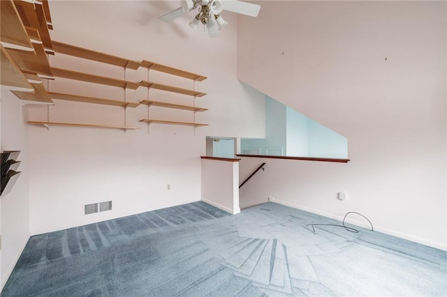 carpeted empty room with visible vents and a ceiling fan