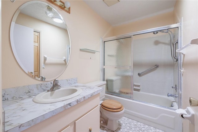 bathroom featuring combined bath / shower with glass door, toilet, and vanity