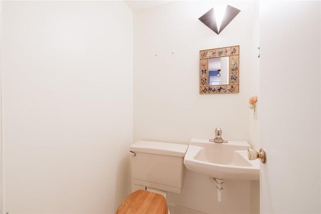 half bathroom with toilet and a sink