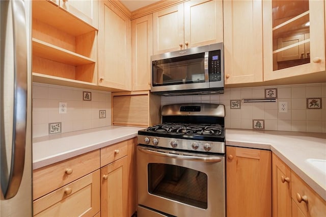 kitchen with stainless steel appliances, backsplash, light brown cabinets, and light countertops