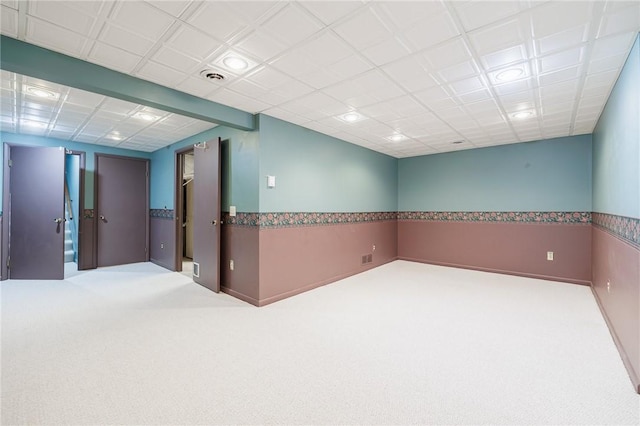 unfurnished room featuring visible vents and carpet