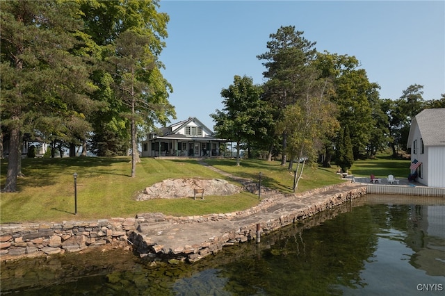 dock area featuring a lawn and a water view