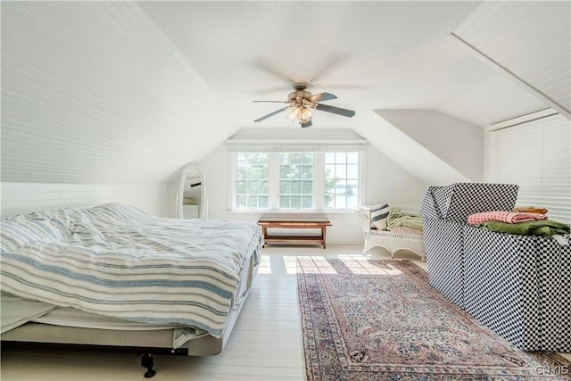 bedroom with vaulted ceiling, wood finished floors, and ceiling fan