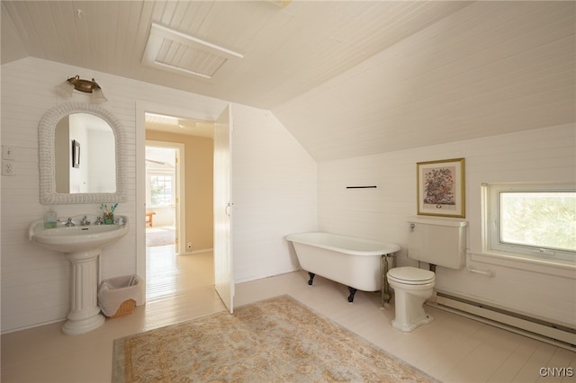 bathroom with lofted ceiling, baseboard heating, plenty of natural light, and a freestanding bath