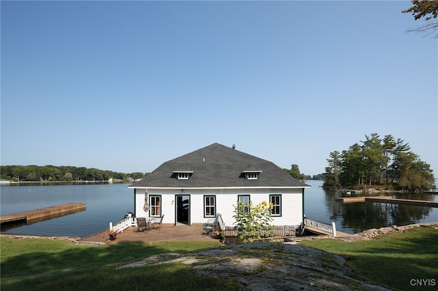 dock area featuring a lawn and a water view