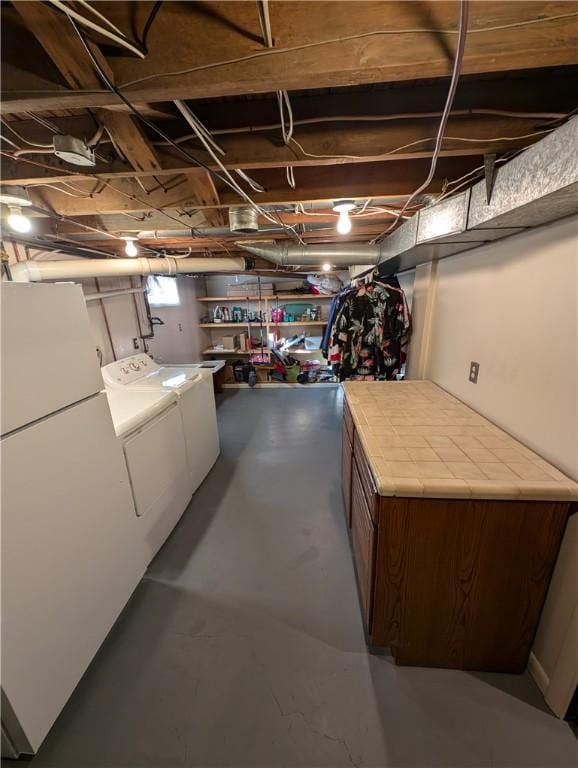 basement with independent washer and dryer and freestanding refrigerator