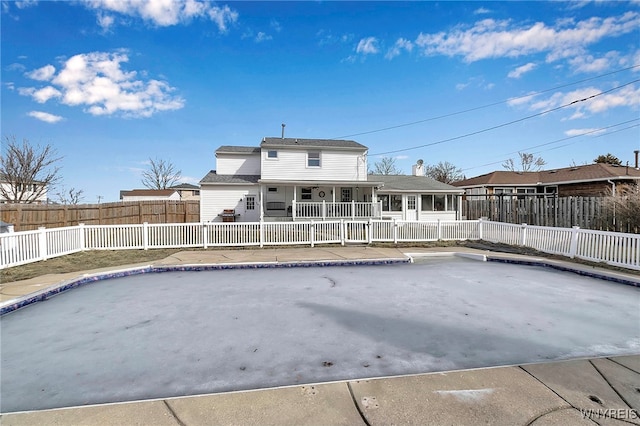 back of house featuring a fenced backyard