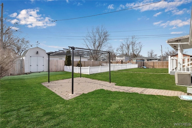 view of yard with an outbuilding, a pergola, a patio, a fenced backyard, and a storage shed