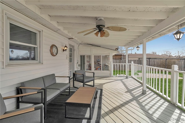 deck with an outdoor living space, a ceiling fan, and fence