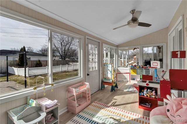 sunroom / solarium with ceiling fan and vaulted ceiling