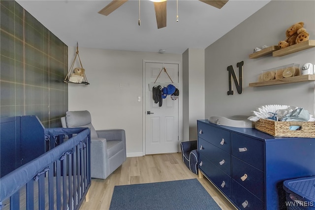 bedroom with light wood-style flooring and ceiling fan