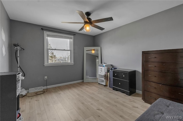 bedroom featuring visible vents, baseboards, light wood finished floors, and ceiling fan