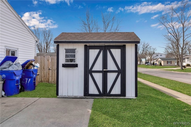 view of shed featuring fence