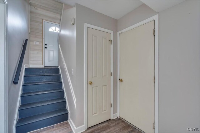 stairs featuring wood finished floors