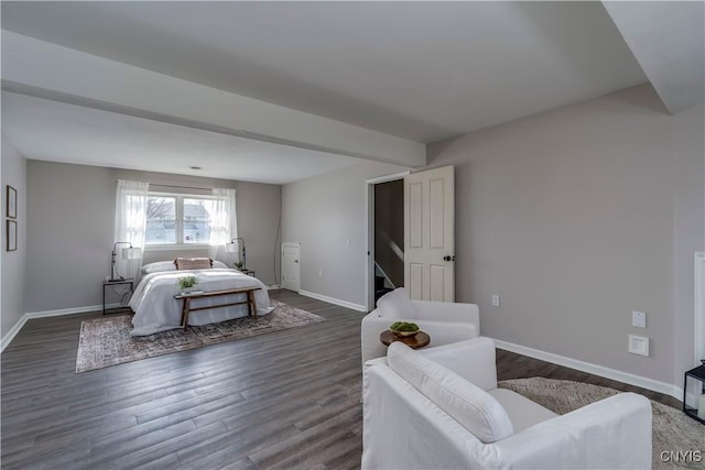 bedroom with dark wood-style floors and baseboards